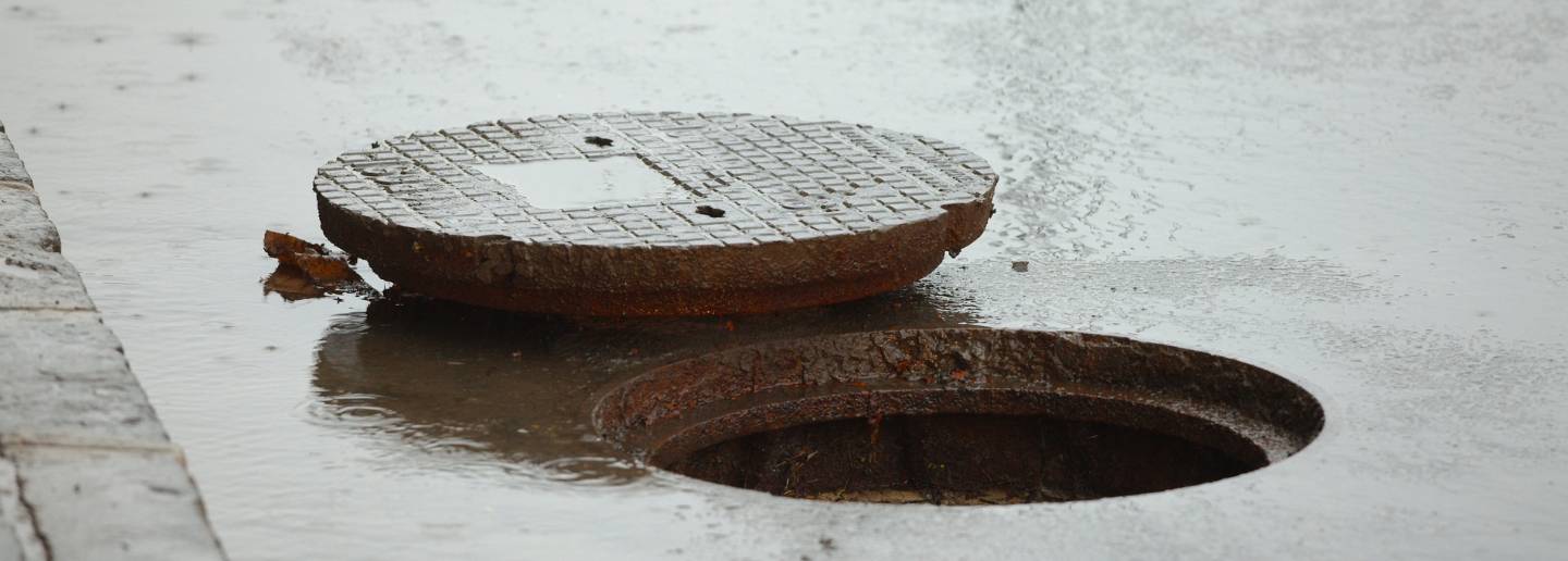 sewer cover open on a rainy street edgewater md